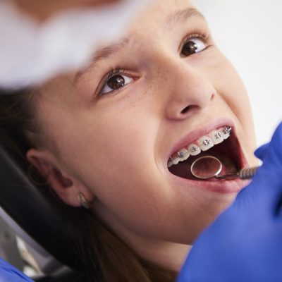 Girl with braces during a routine, dental examination